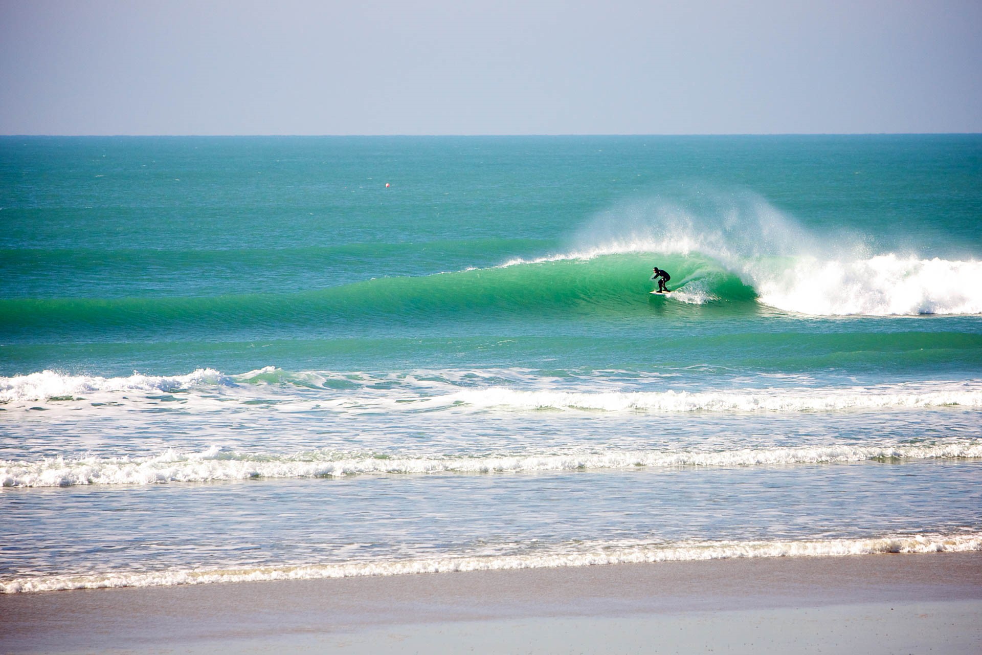 Winter surfer at Secrets, St Ouen's Bay