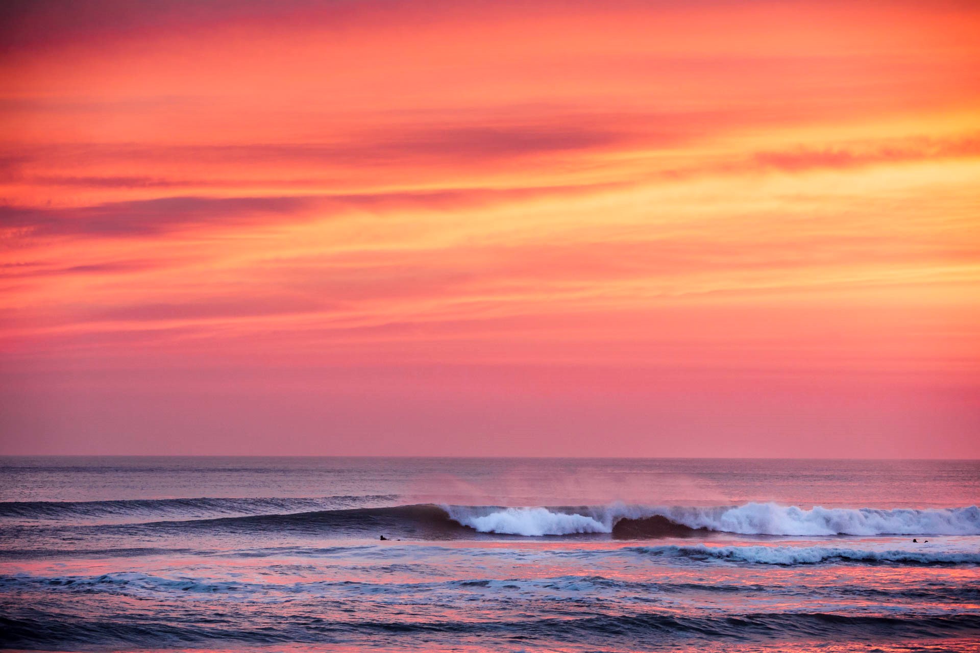 Sunset skies and rolling waves